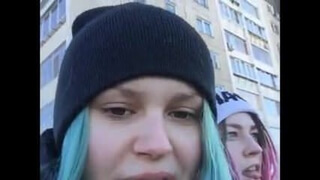 Two girls walk around the city and show their charms